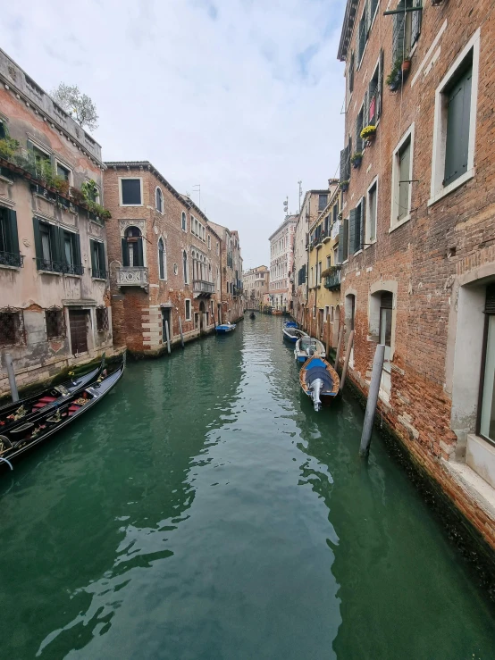 there are gondolas and buildings along this waterway