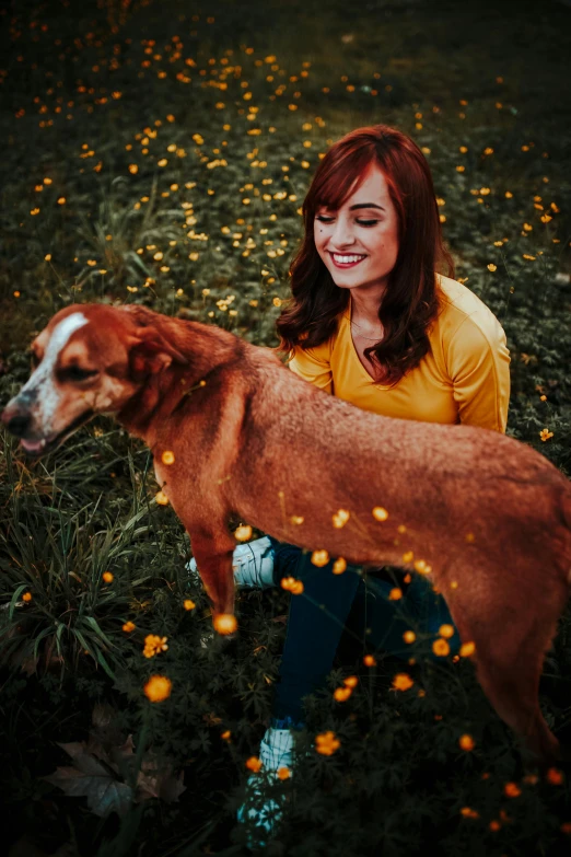 a girl holding a dog in her hands