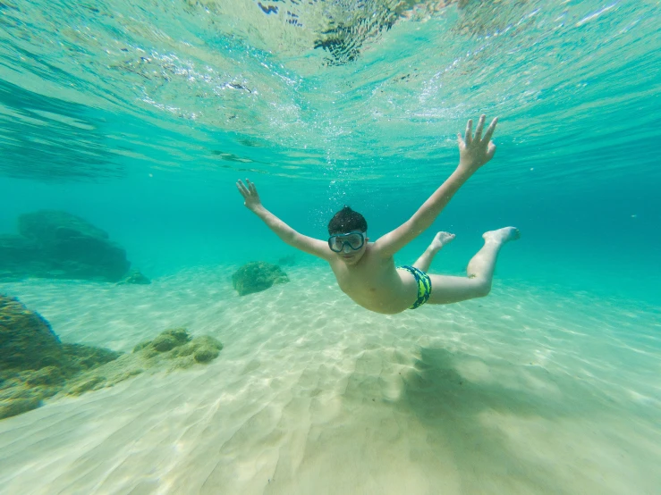 the woman is swimming in a shallow lagoon