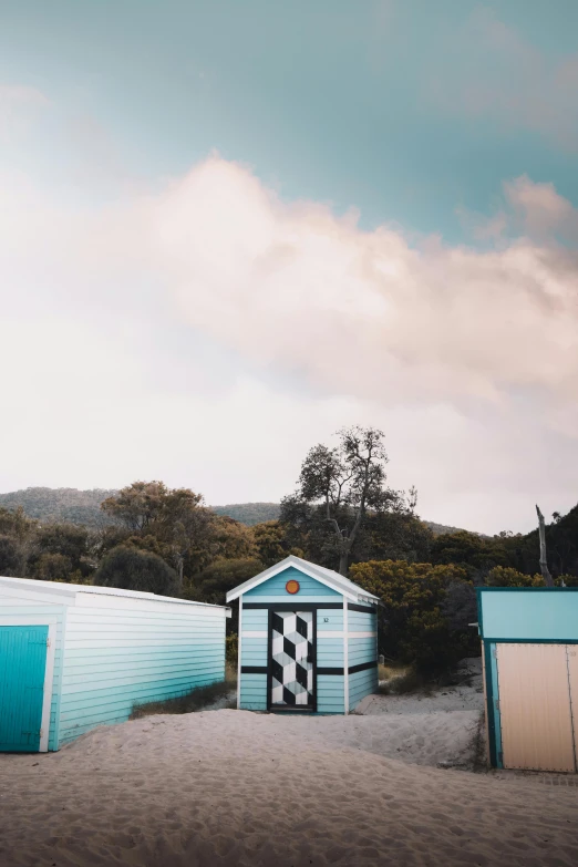 the blue shed and shed are next to the other two structures