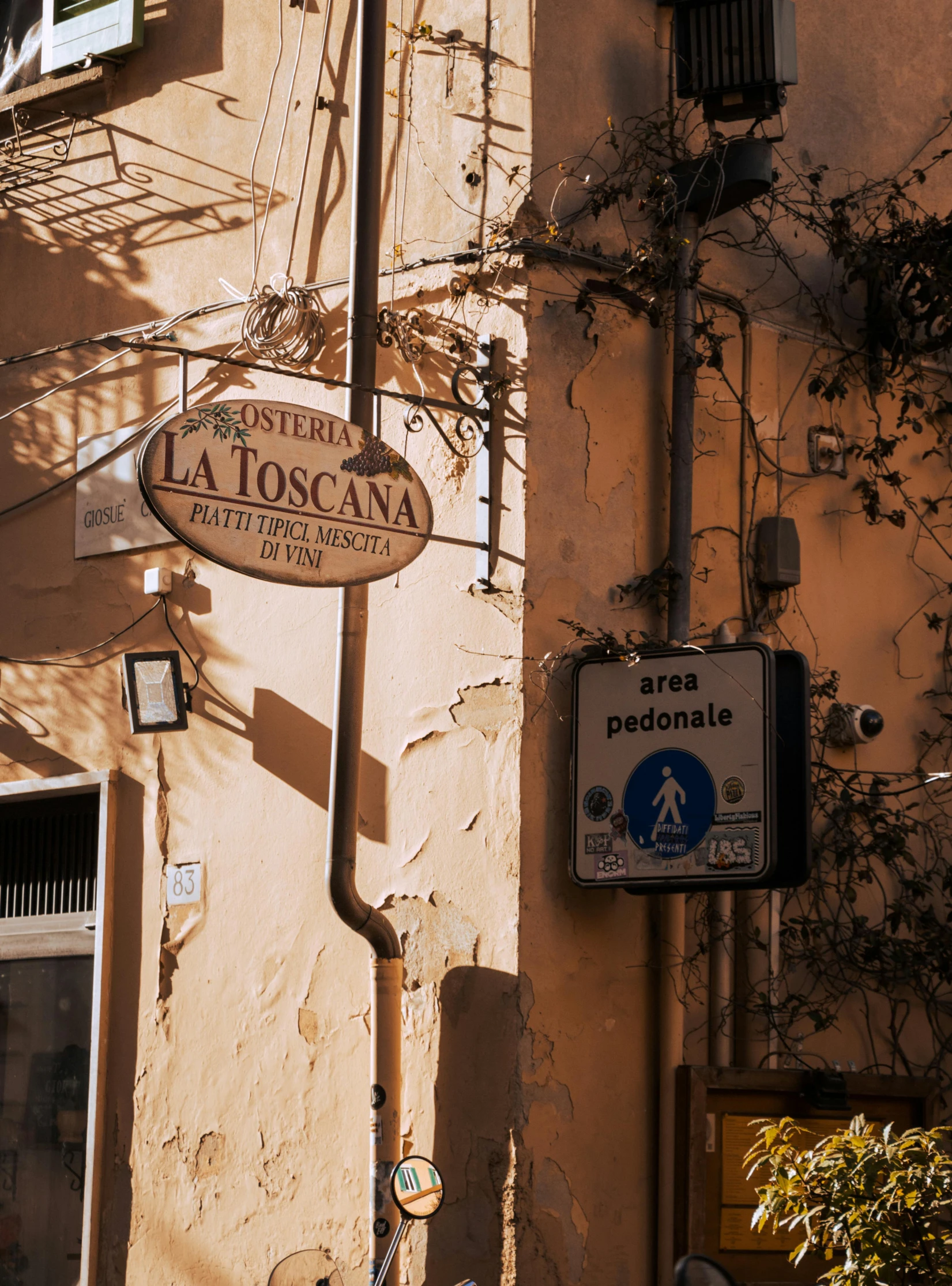 two signs mounted to the side of an orange building