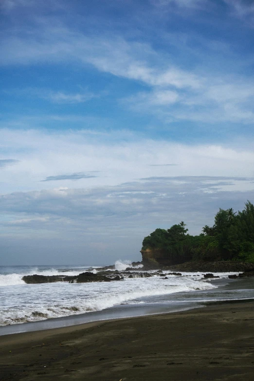 a person is standing on the edge of the beach