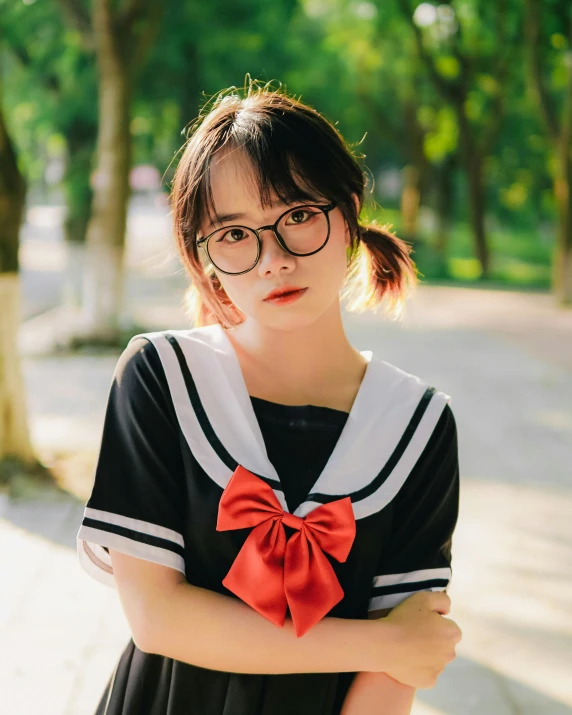 a girl standing with her arms crossed on the street