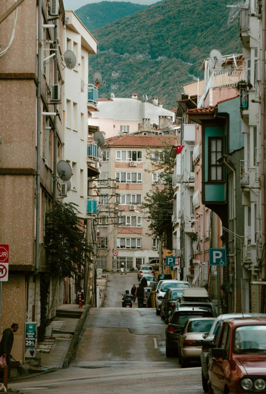 cars are parked on the side of this city street