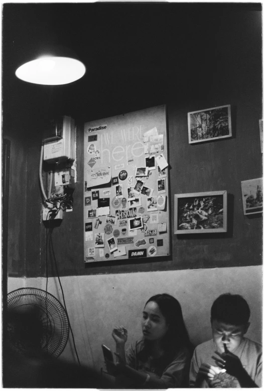 a couple of people are eating food at a restaurant