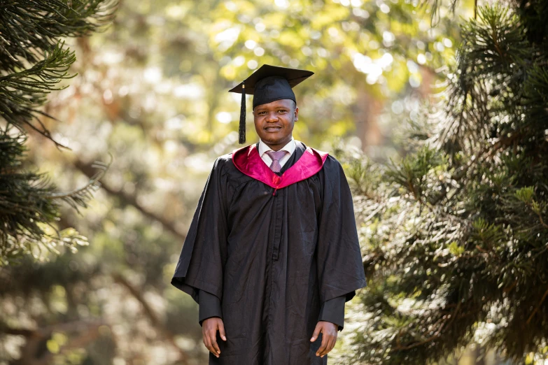 a person in graduation robes posing for a po