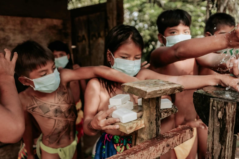 group of people wearing protective masks around a man