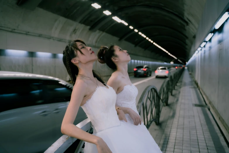 two beautiful women with short white dresses walking down a street