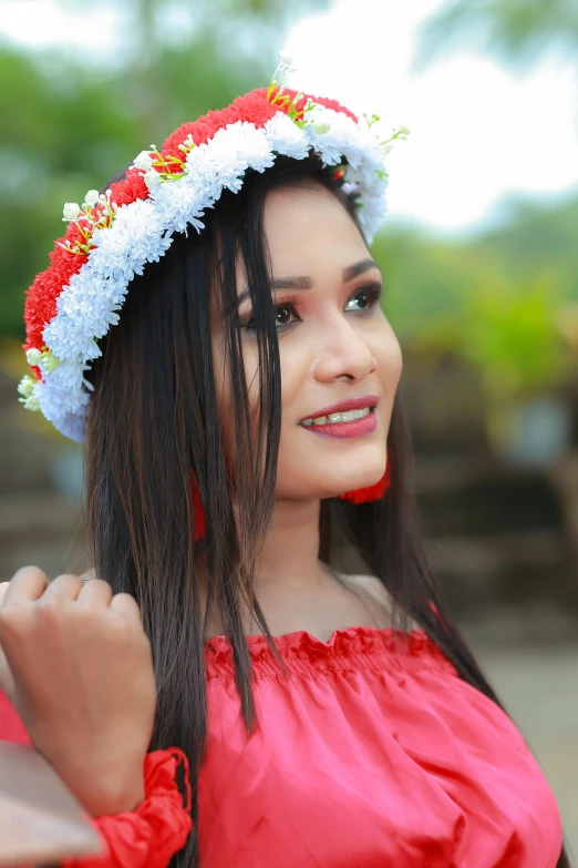 the young woman is wearing a flowery hat