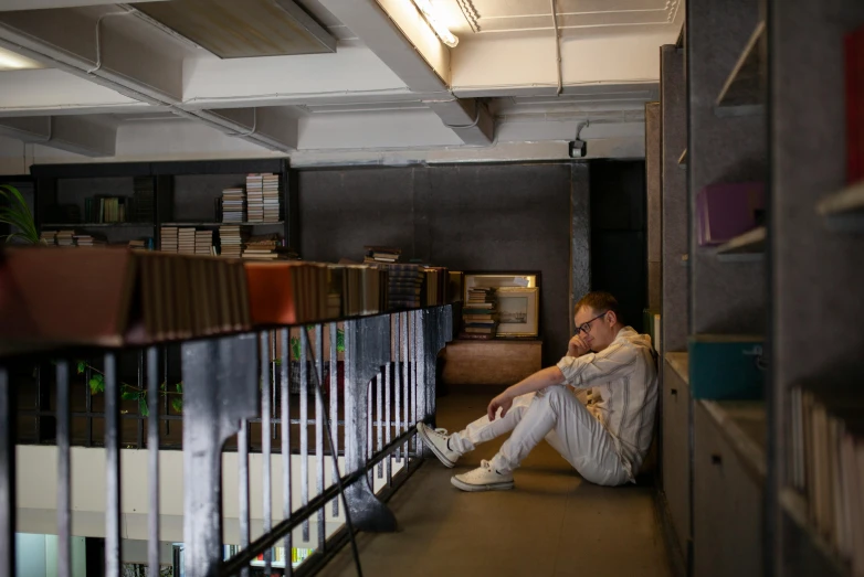 a man with sunglasses is sitting on the floor in an office