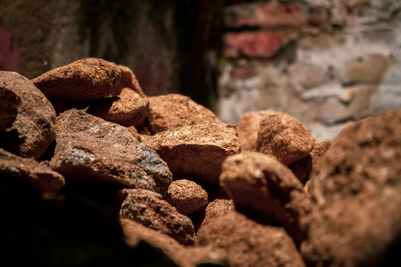 a pile of brown rocks next to a building