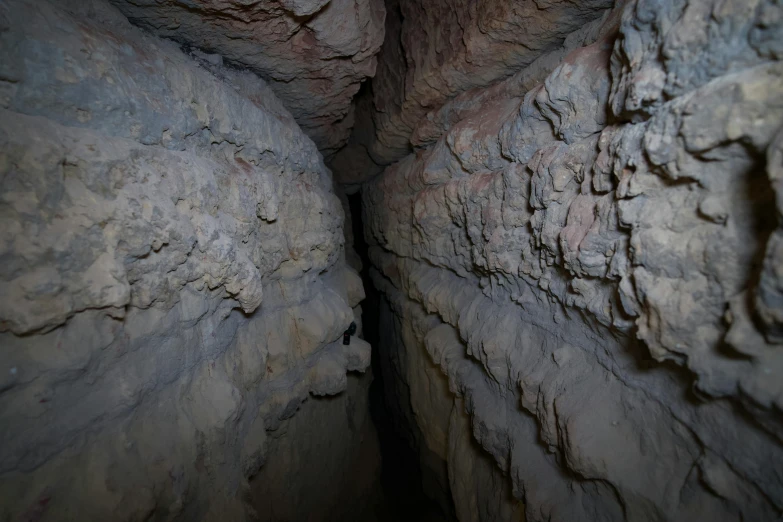 three men are hiking along a narrow trail