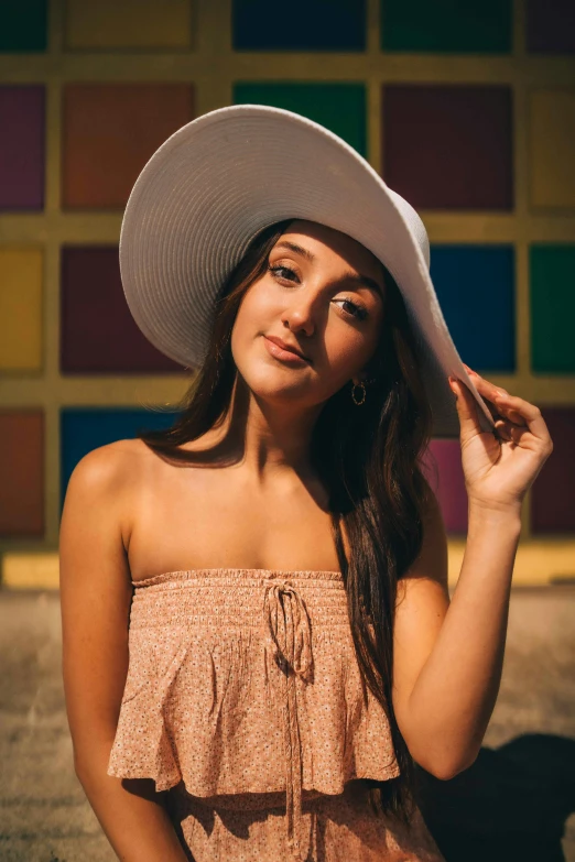 a woman in a hat posing for the camera