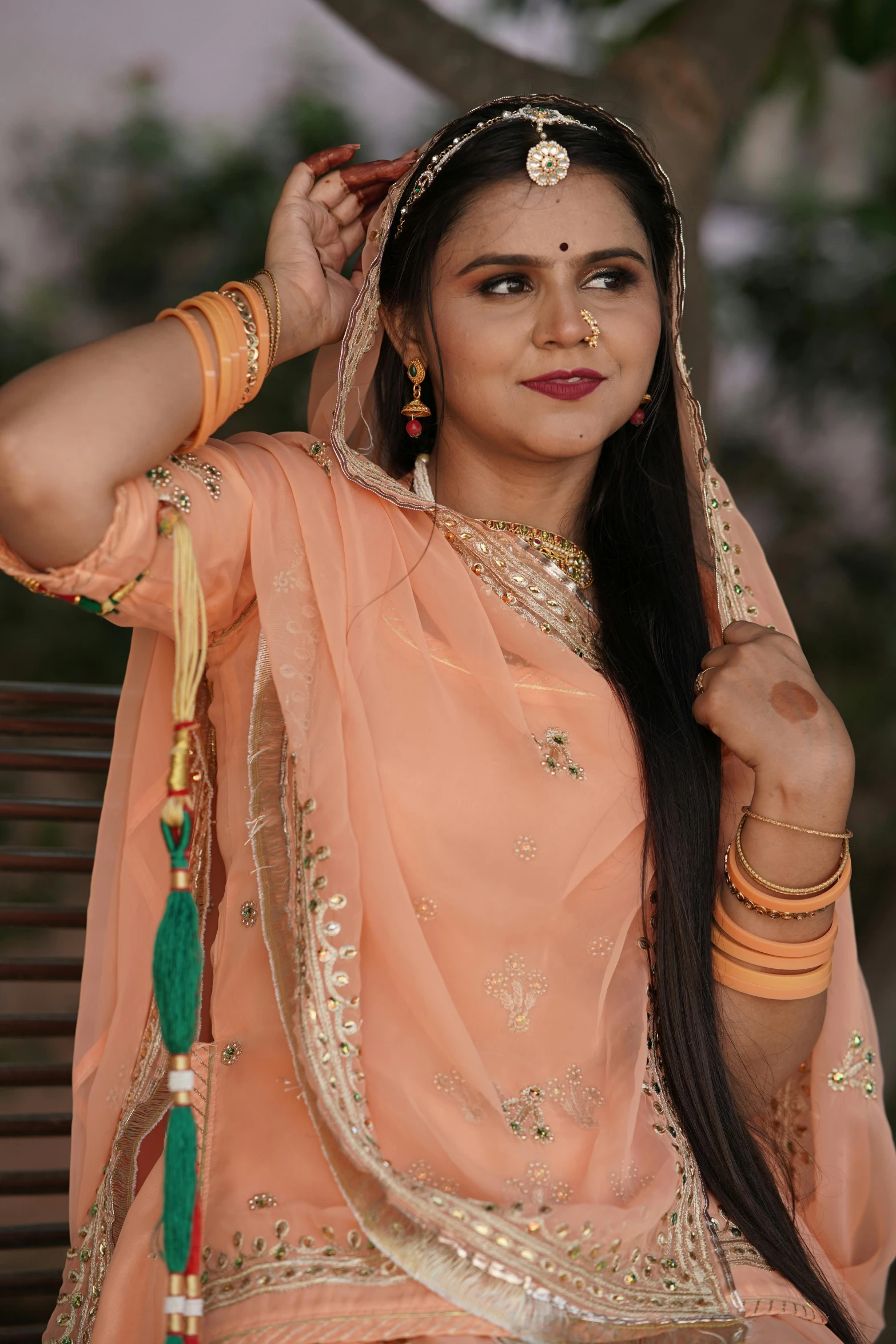 a beautiful young woman wearing a pink lehenga