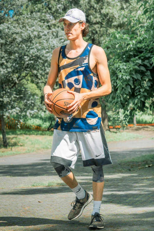 a boy holding a basketball and playing frisbee