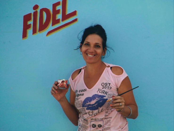 a woman in a pink tank top holding soing