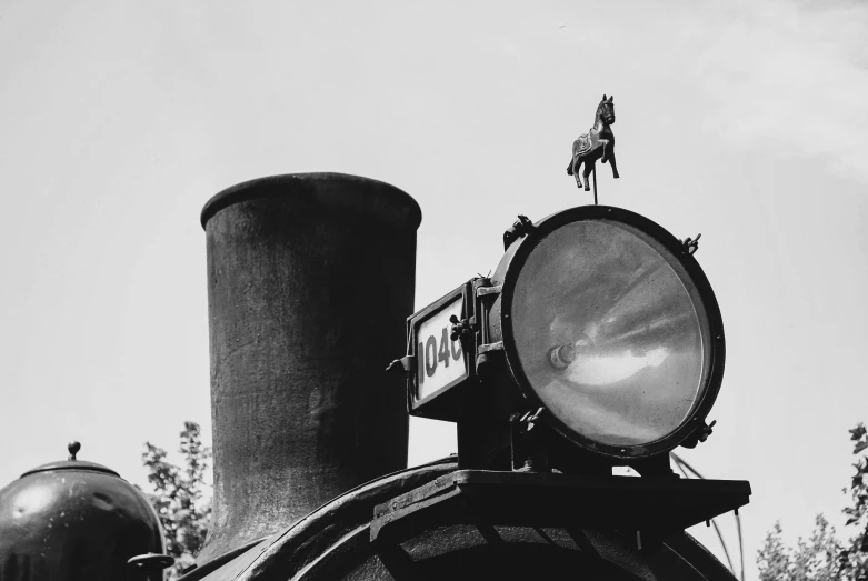 the side view of a train with its lights on