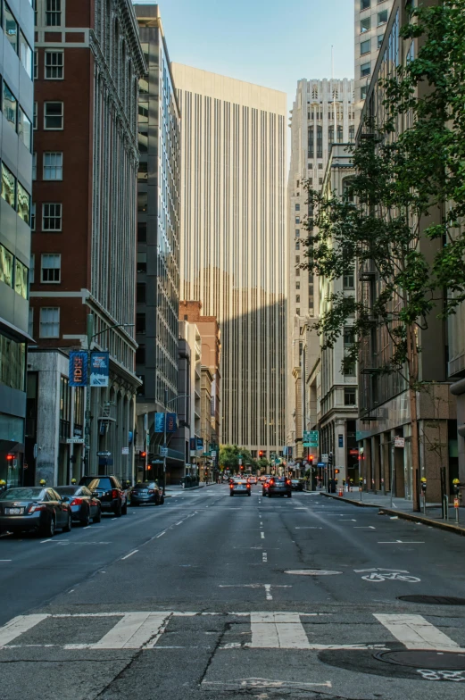 an empty city street in the middle of a downtown area