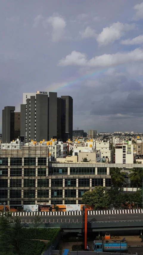 some buildings with a rainbow in the sky