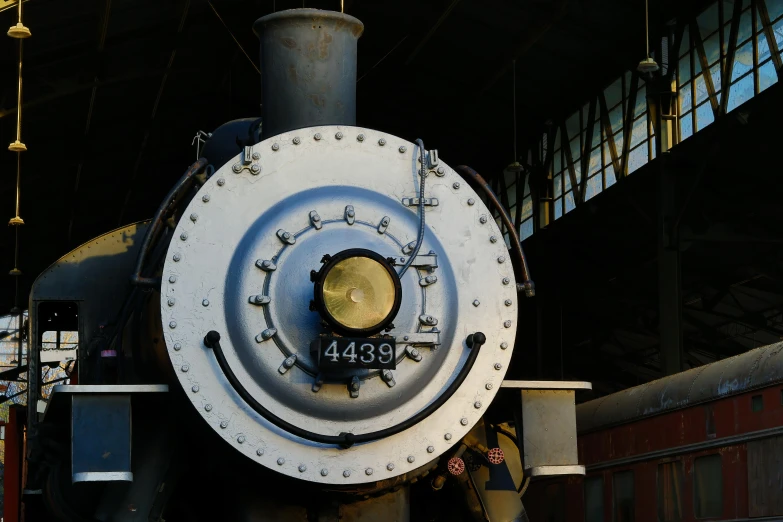 an old white train engine in a building