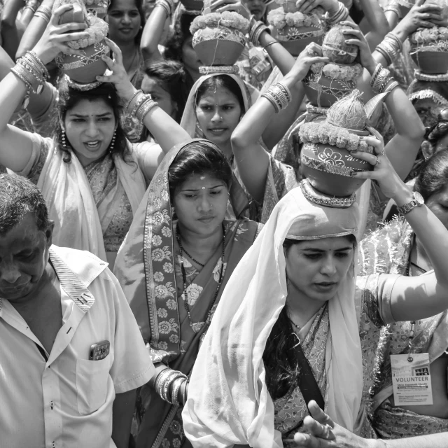 a crowd of people holding their hands up to hats