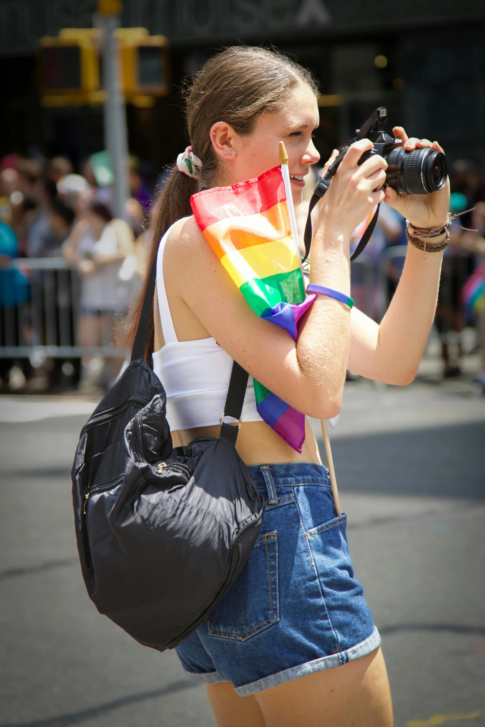 a woman standing on a street holding a camera