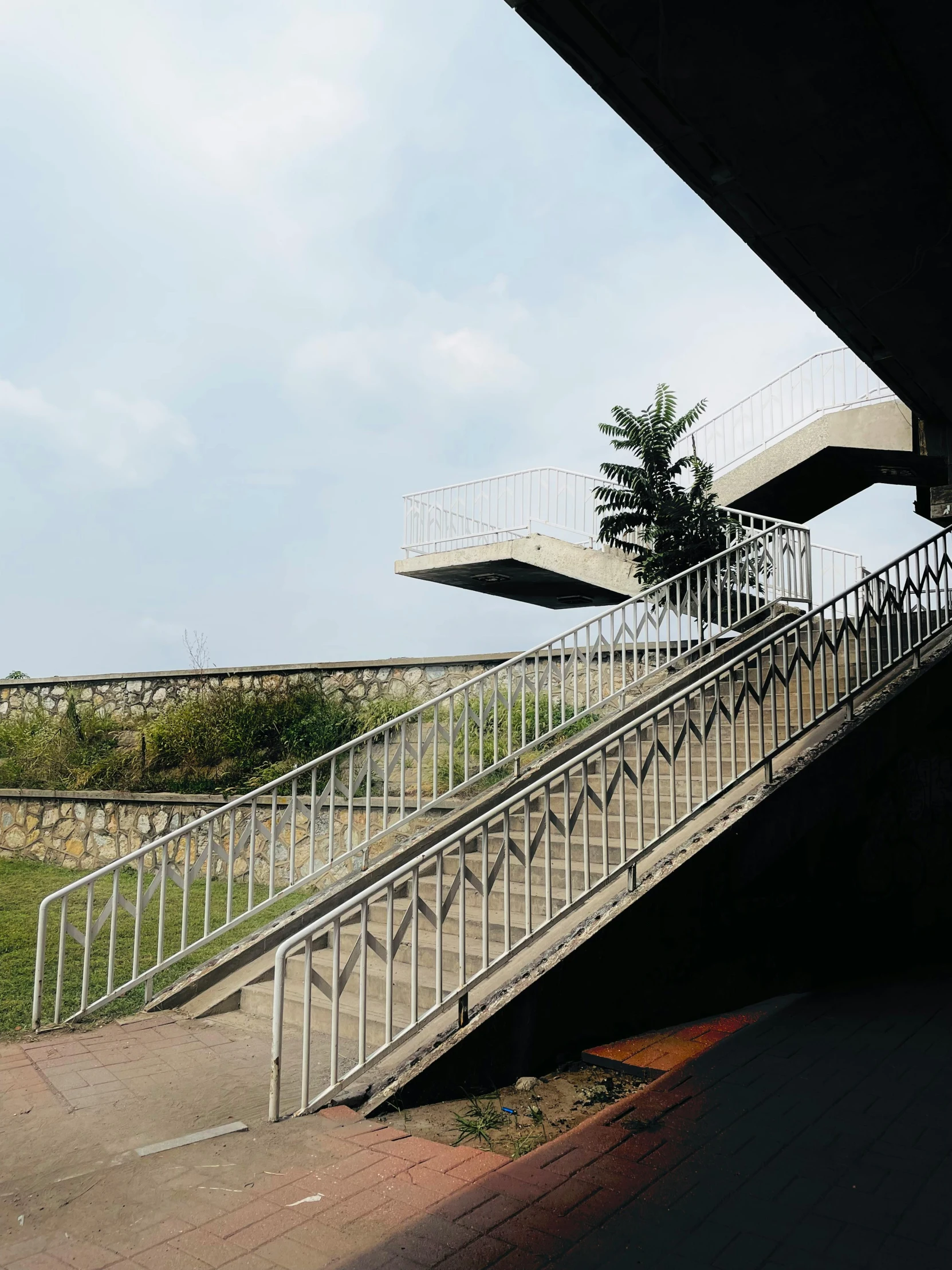 an outdoor walkway and steps with trees at the end