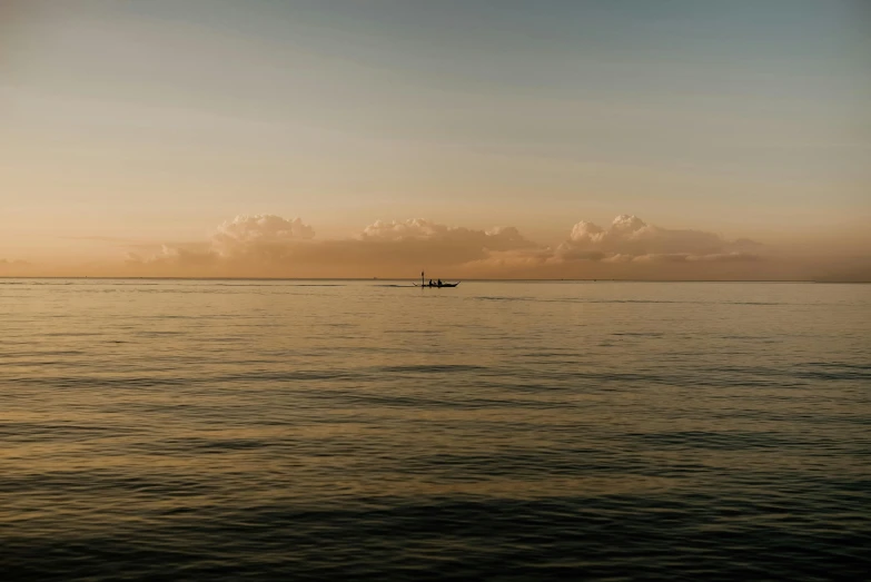 an empty boat sitting in the middle of a large body of water