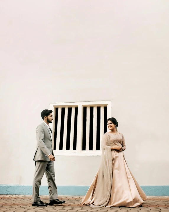 bride and groom standing in front of a window