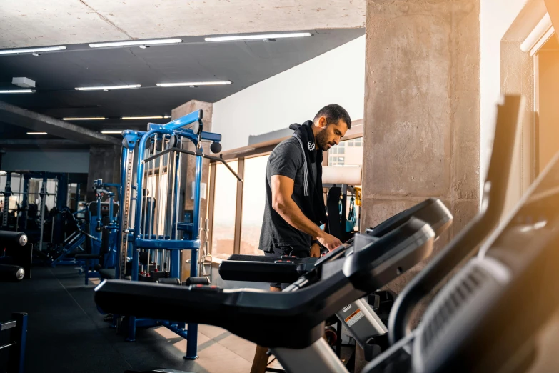 a man walks around the gym on a stationary tread