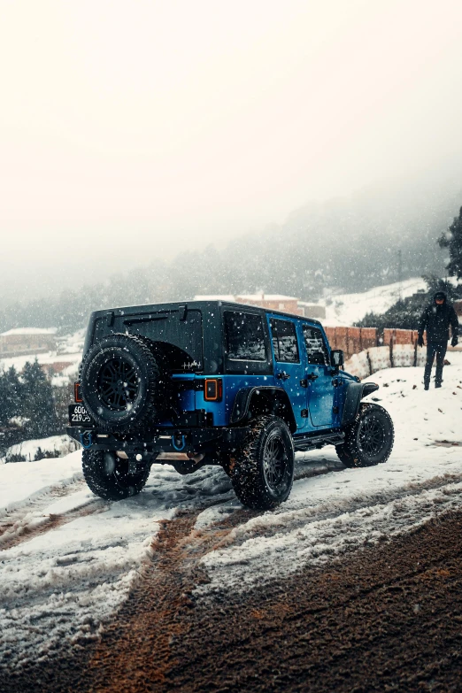 a truck in the snow at dusk on a snowy day