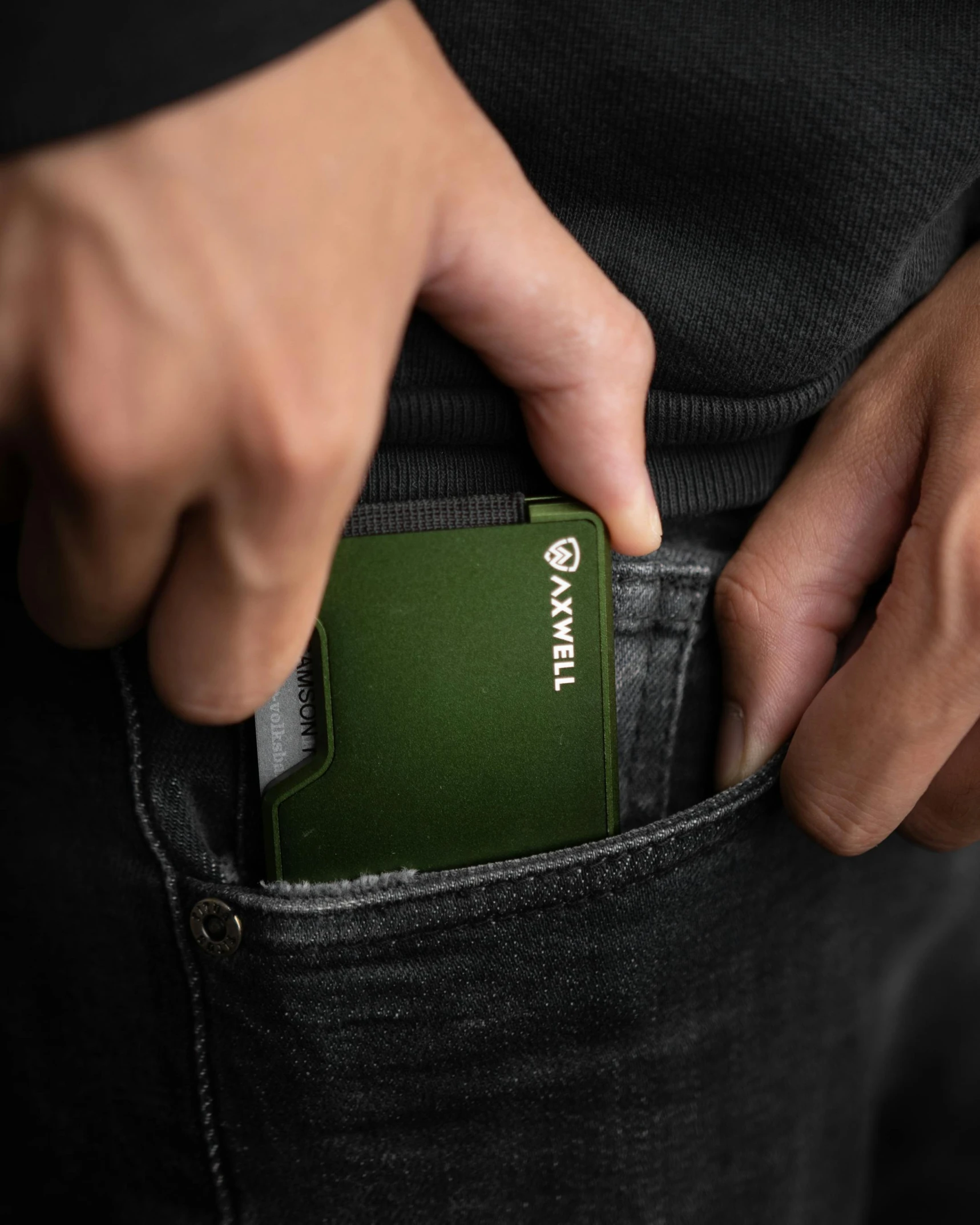 a man holding his wallet in his pocket