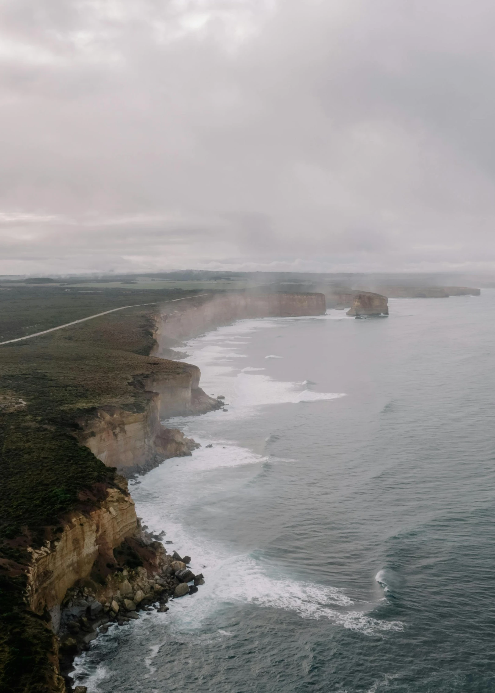 a view of the coast from above with a helicopter flying over it