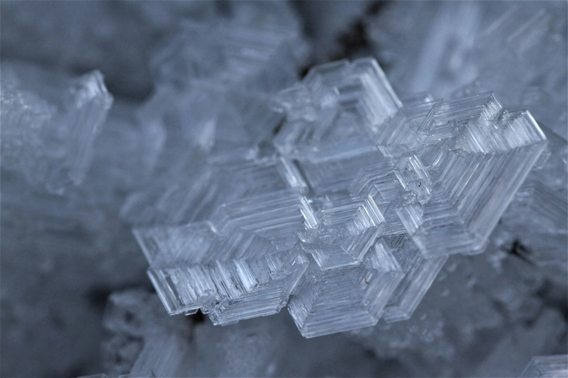 a crystal like object laying in some ice