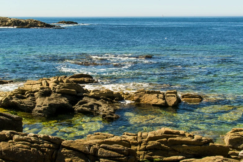 a small body of water with rocks on the side