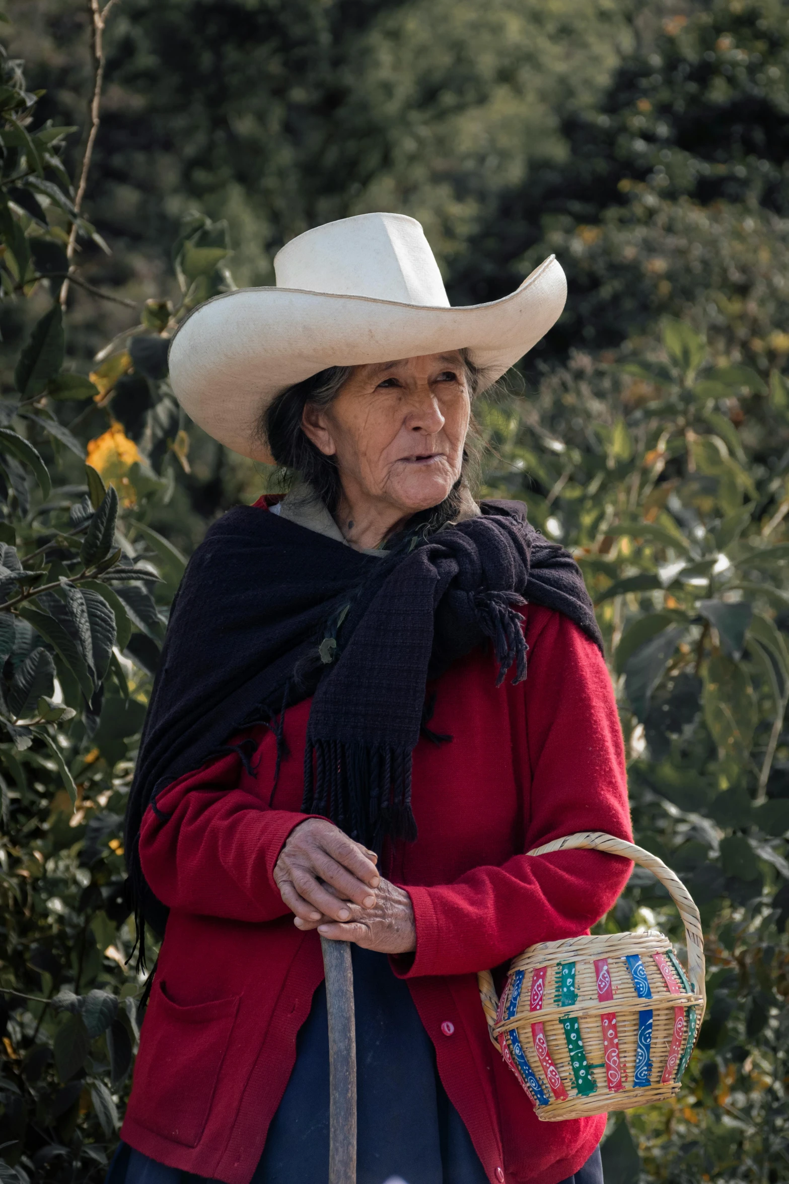 an older woman in a cowboy hat and blue dress