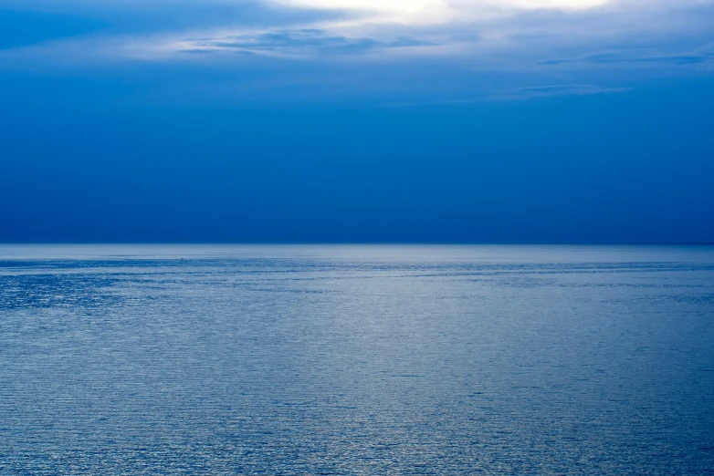 a small boat is seen in a calm blue ocean