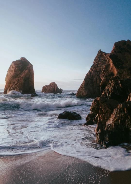 rocks in the water at an ocean beach