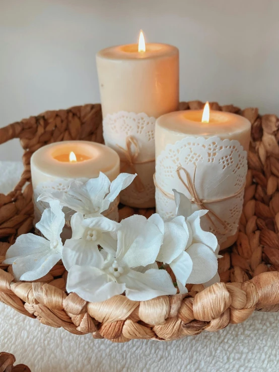 a basket with some flowers and candles on it