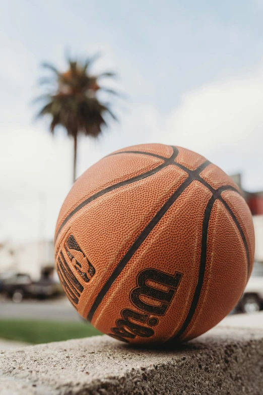 an orange basketball that is on the cement