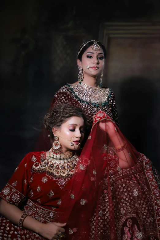 two women dressed up in ethnic attire and jewelry