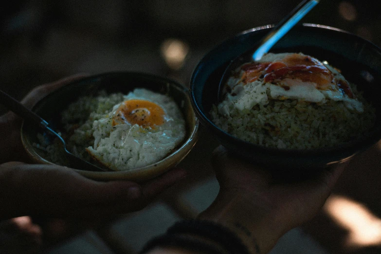 a person eating food in a black bowl