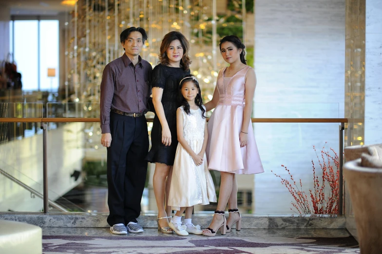 a family standing on a balcony posing for a picture