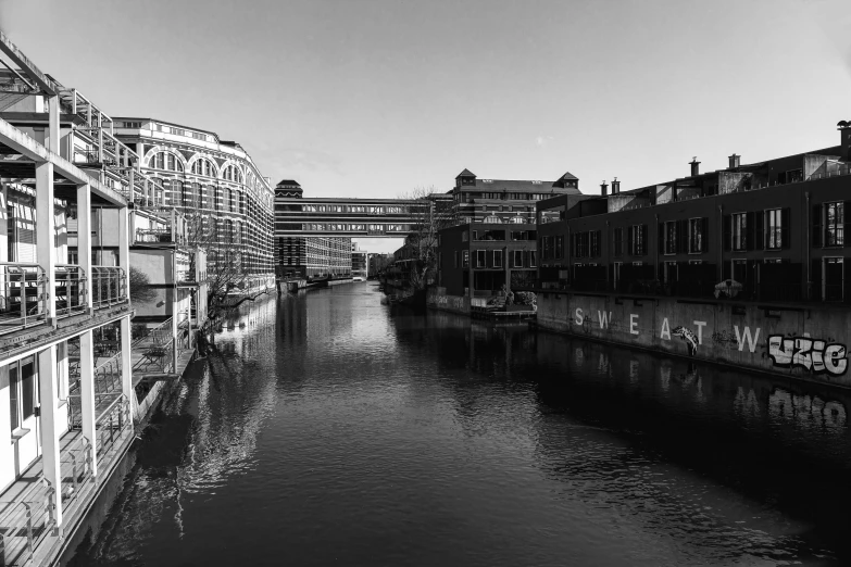 black and white pograph of waterway with old buildings