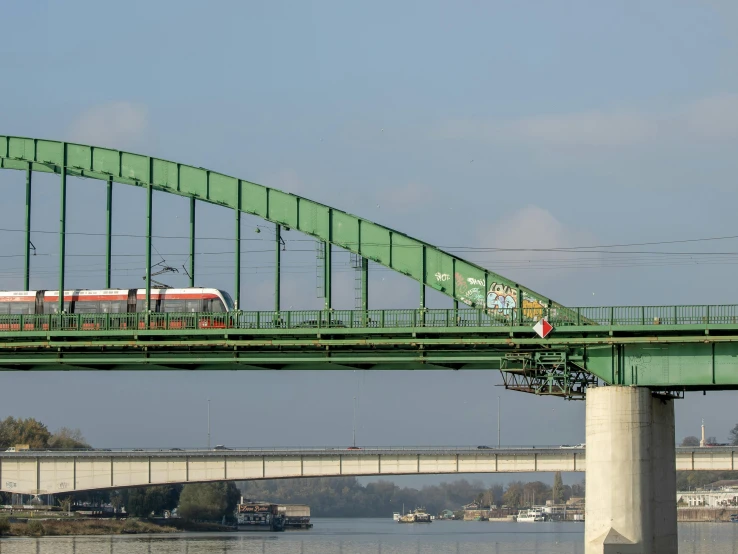 a train is crossing over the water on a bridge