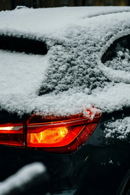 the back end of a car covered in snow