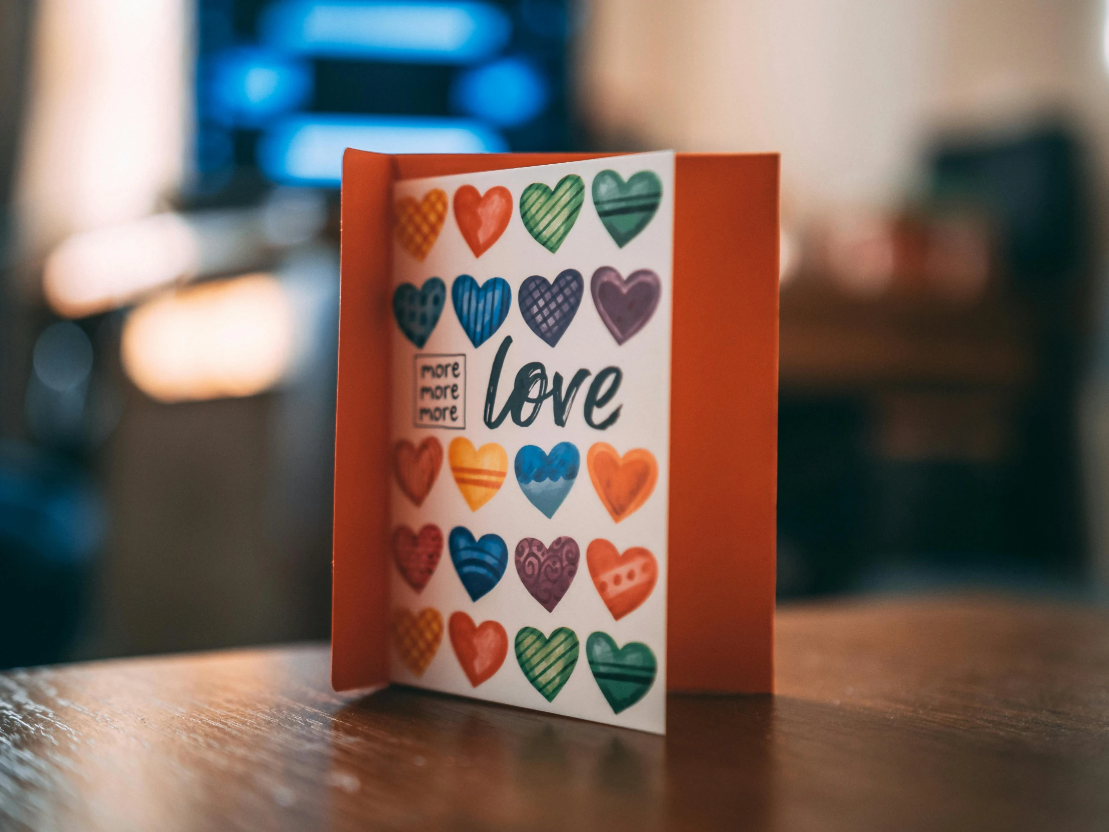 a greeting card has colorful hearts on it