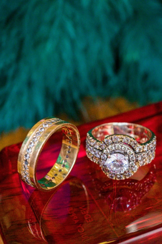 two rings on a red table with green background