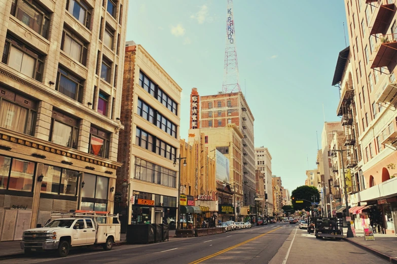 a street lined with tall buildings next to a tall building