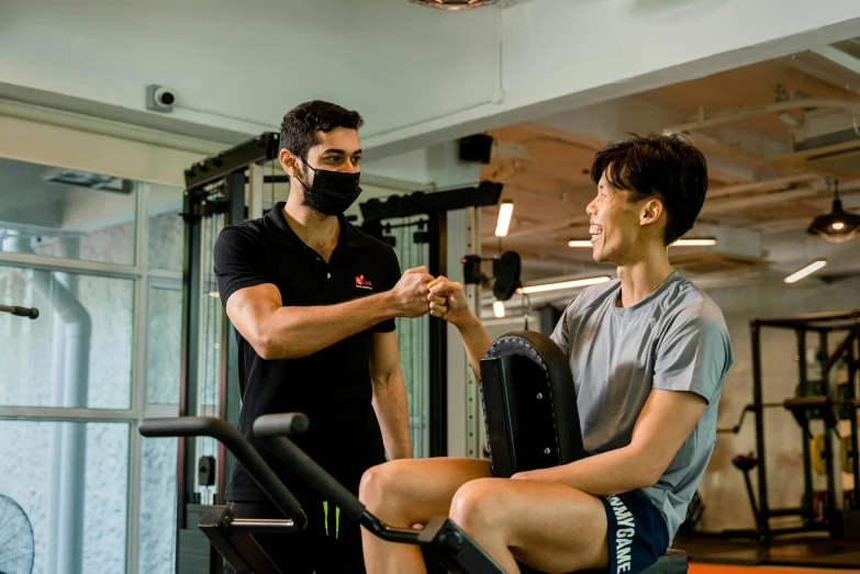 a man with a face mask is using an exercise machine